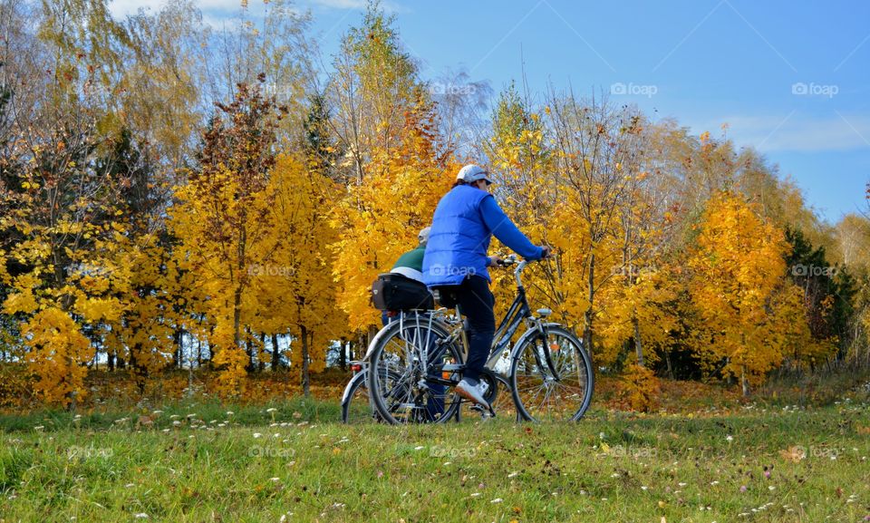 people riding on a bikes autumn beautiful landscape