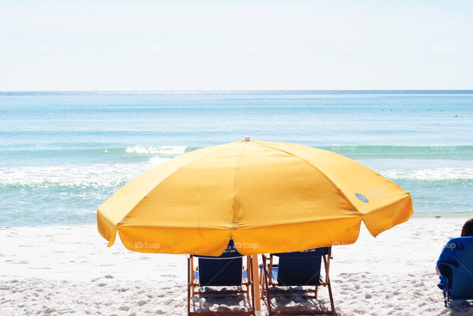 A yellow umbrella at Miramar beach, Fl