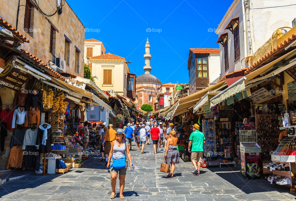 Shopping street, Rhodos. Shopping street in old town of Rhodos on a bright sunny day. Many tourists visiting Rhodos, Greece in summertime.