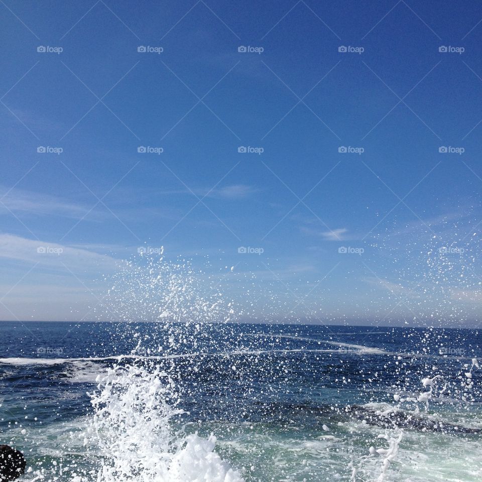 Splash. Splashing seawater against a bright blue sky