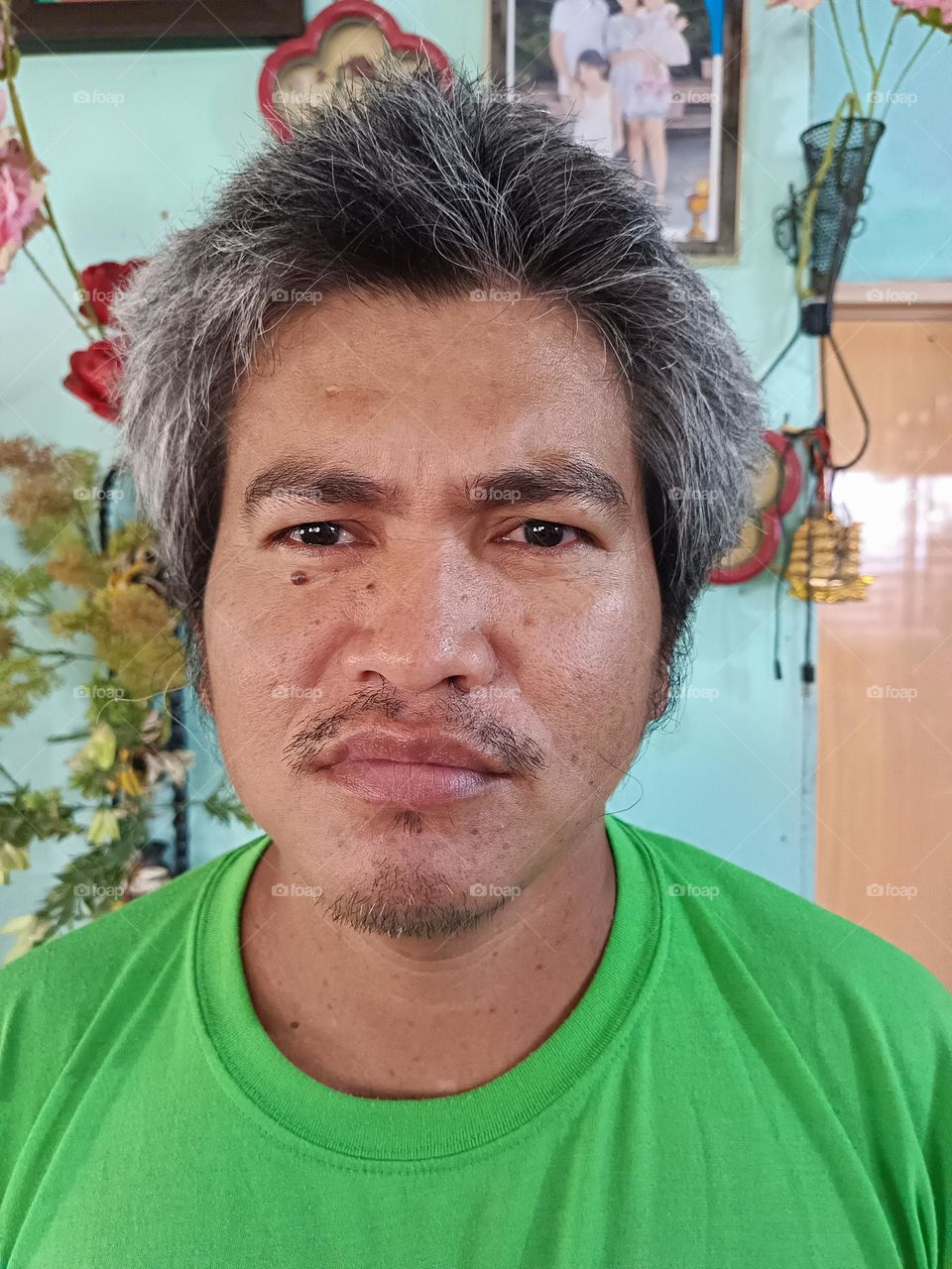 "A subtle mustache, a mark of character and quiet confidence, adding depth to his calm and steady expression."