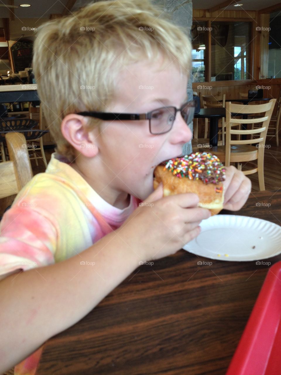 Boy eating doughnut 