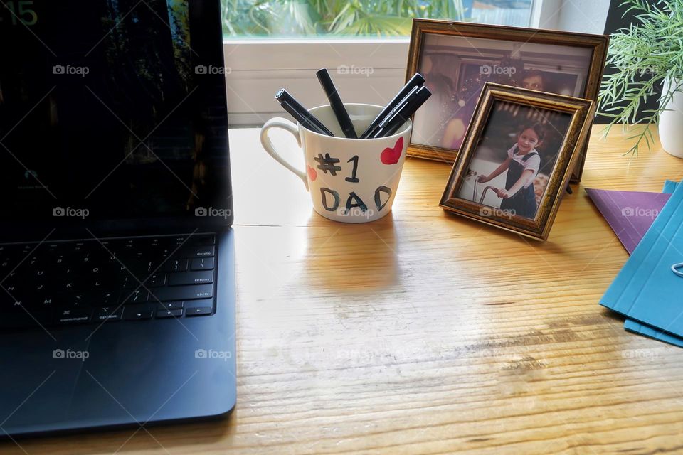 Father working at desk surrounded by reminders of family