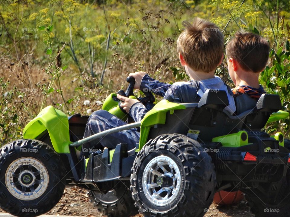 Young Racers. Boys Driving Together In A Toy Offroad Car