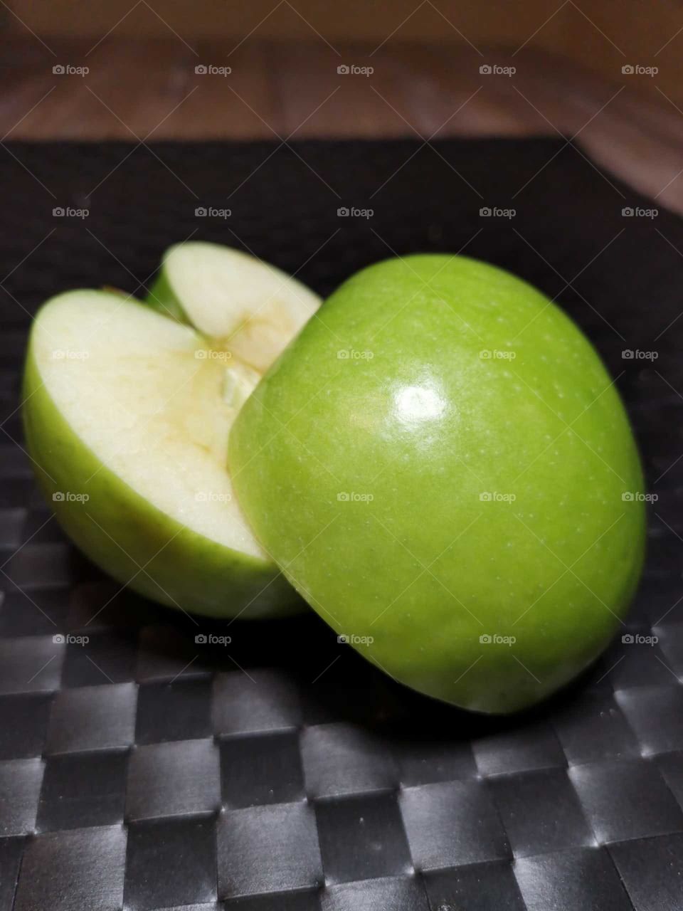 Green apple that is cut in half