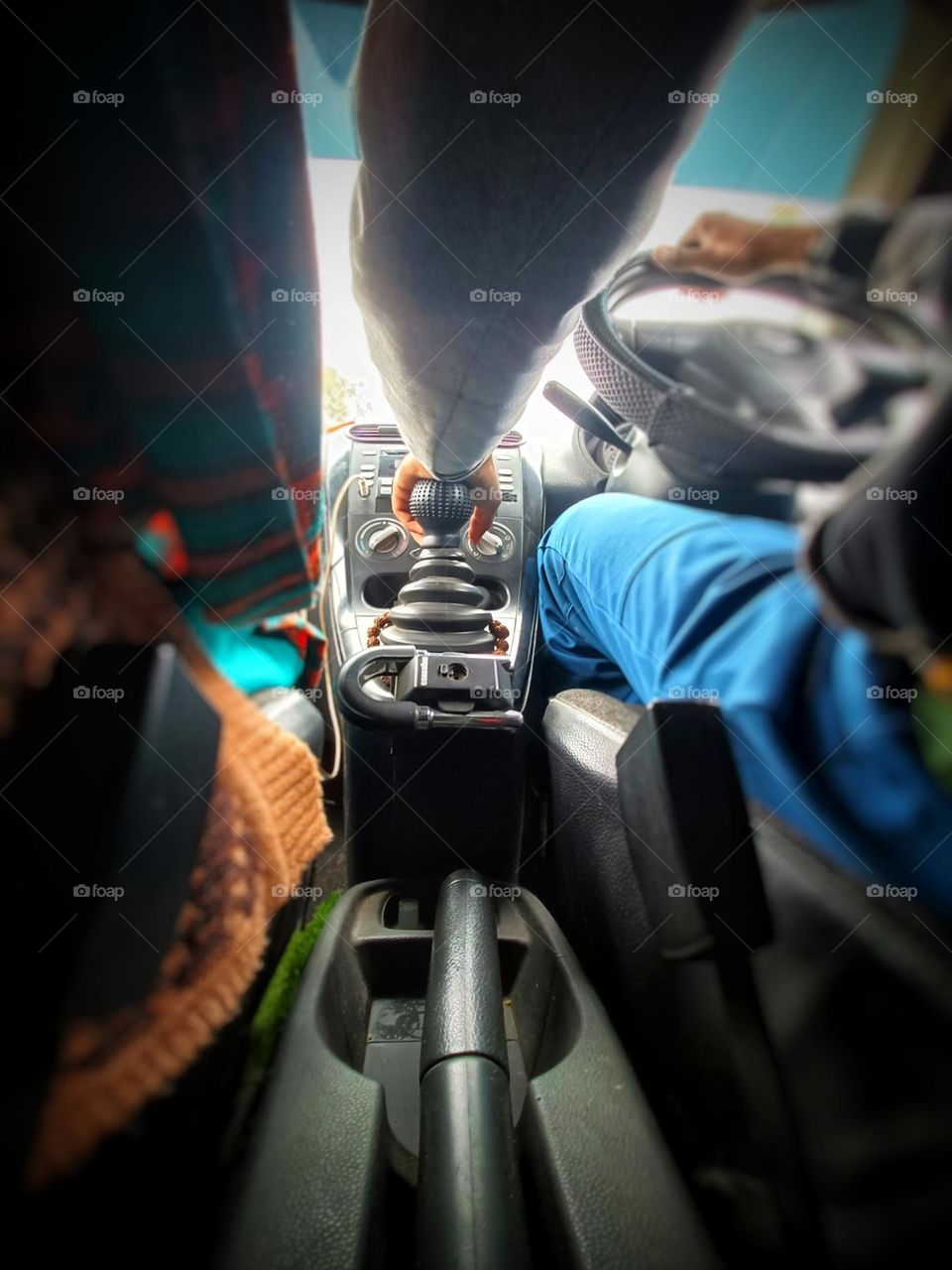 a man changing gear while driving.