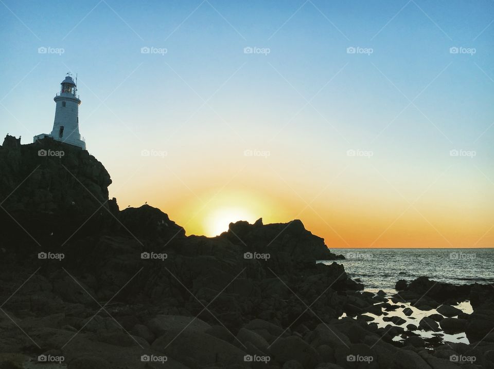 Sunset over a lighthouse in jersey 