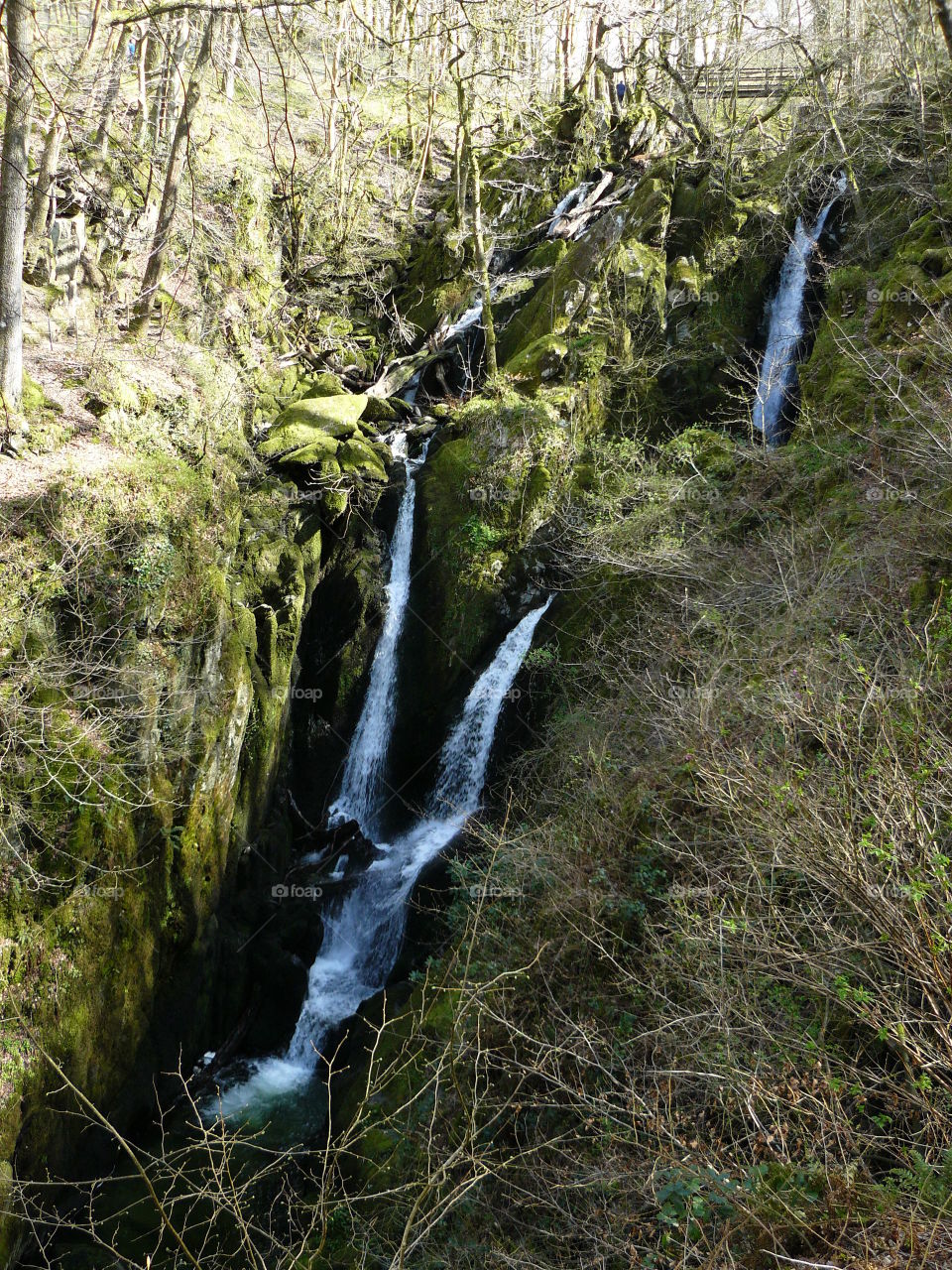 waterfall in woodlands green spaces beautiful lake district