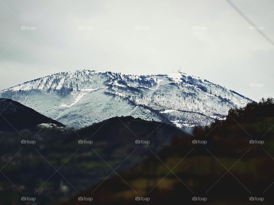 the snow slowly descends down the mountain