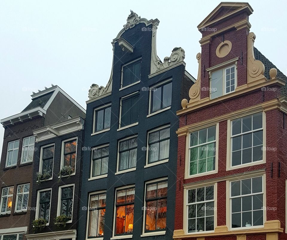Beautiful and vintage architecture roofs and windows on buildings on an old alley street in Amsterdam, Holland, Europe.