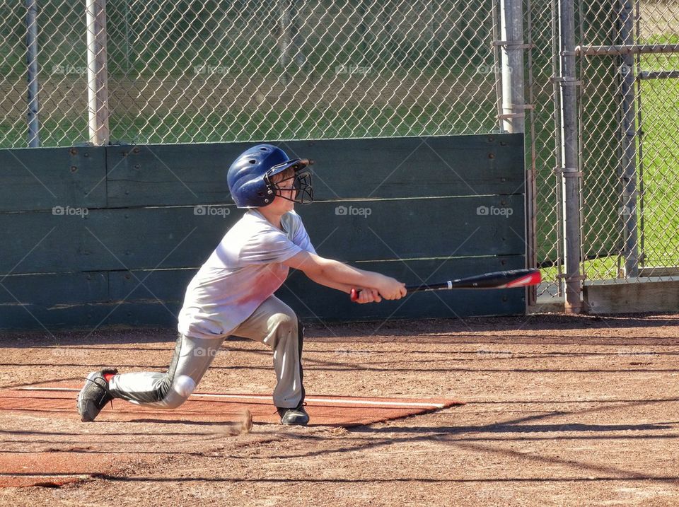 Little League Baseball Player Swings For The Fences. Youth Baseball In America