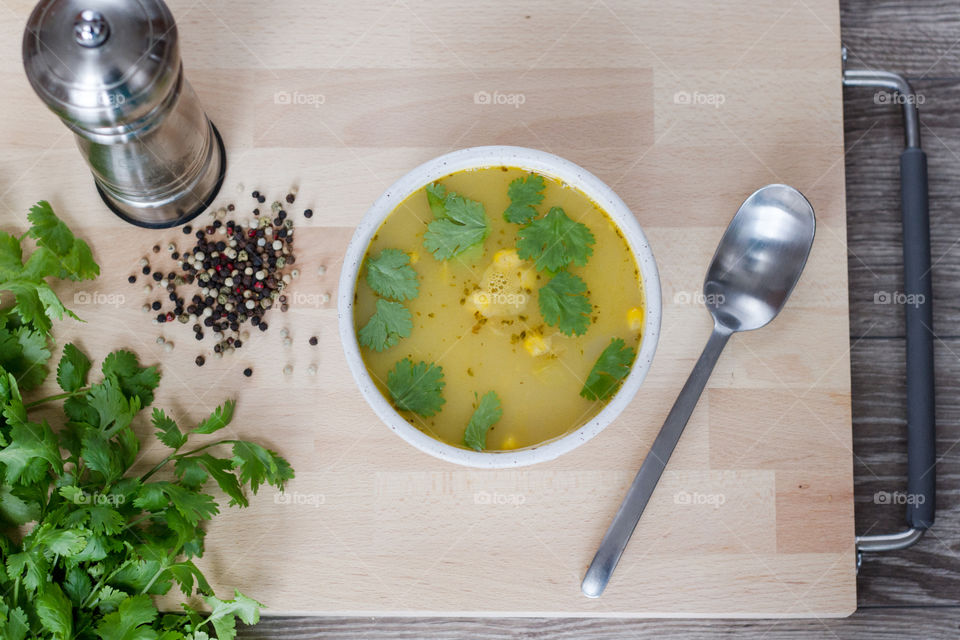 A bowl of soup with fresh spices