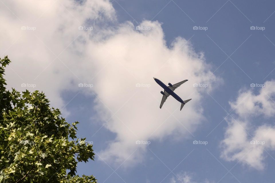 Airplane against sky with clouds