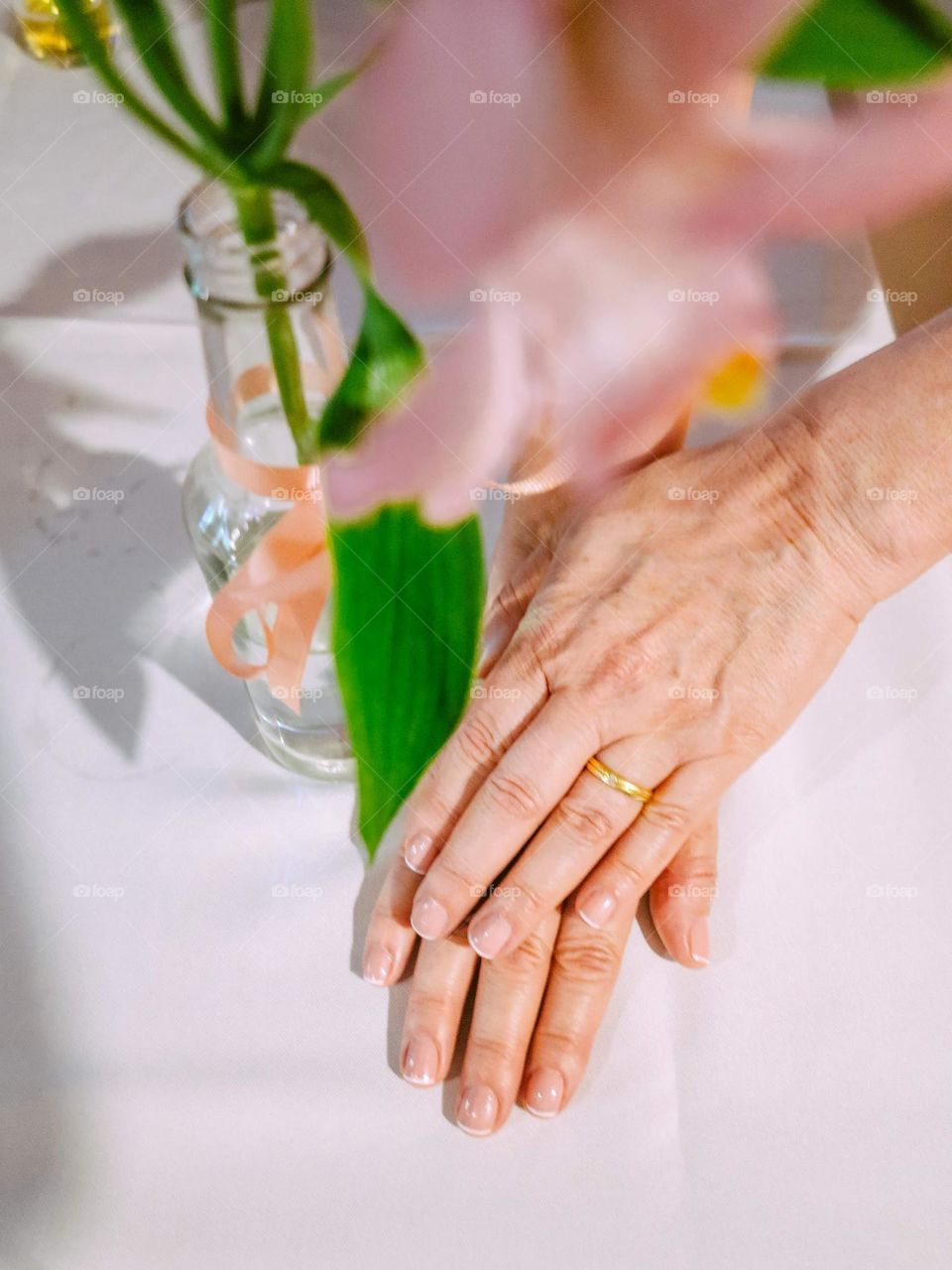 Hands of a bride showing her weeding ring at the wedding ceremony. Very lovely and happy moment.