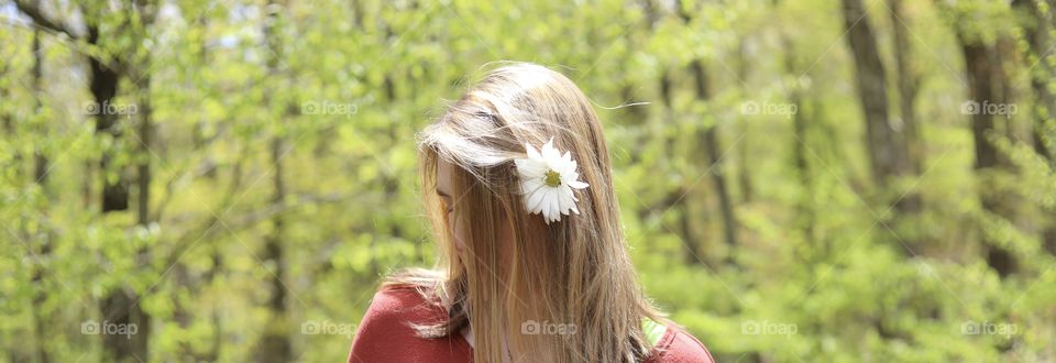 Daisy Day; Woman in Spring bloom with daisy behind ear