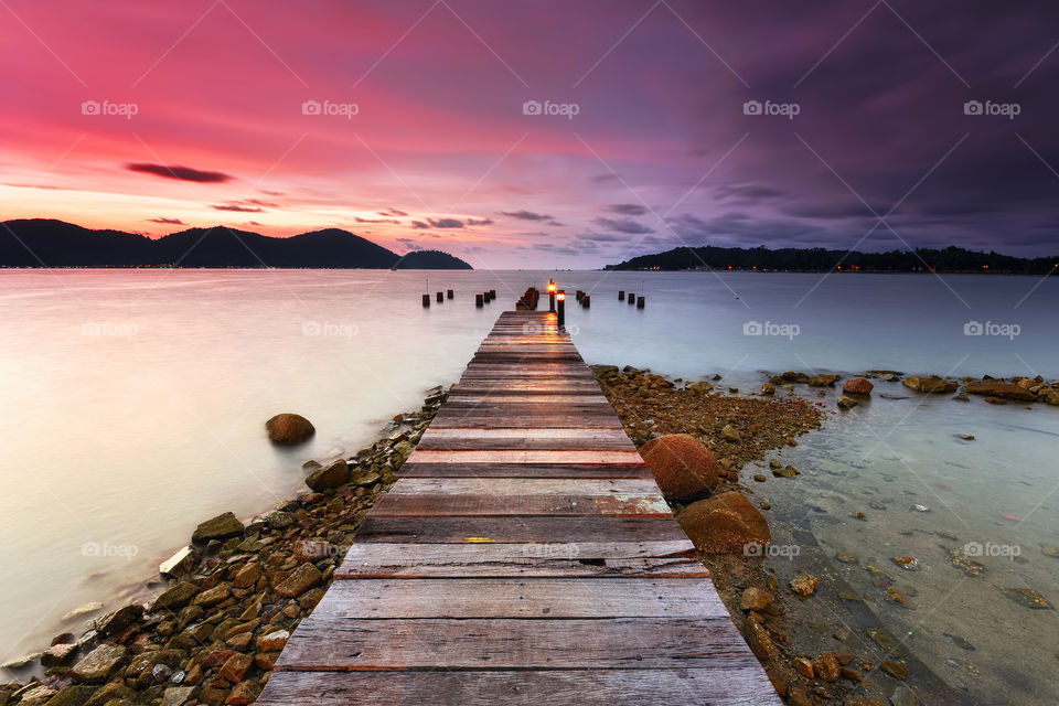 Sunset over the wooden jetty