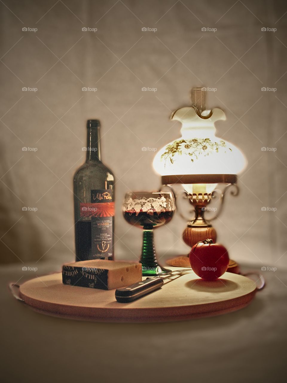 cheese ˋn vine. stil life of bottle vine with chees, tomato and old fashioned lamp