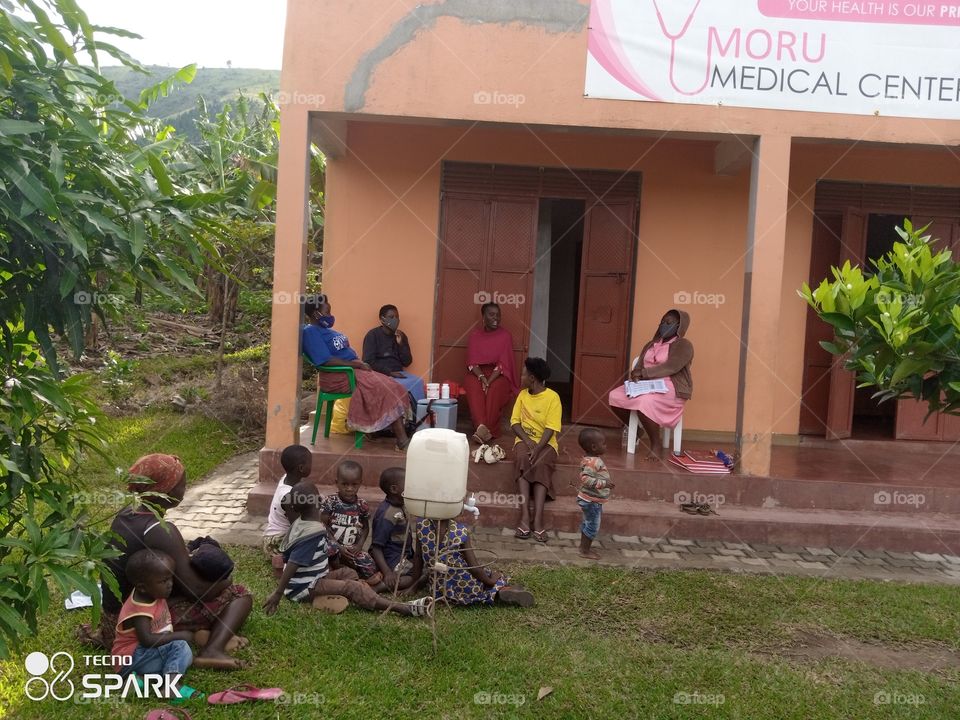 people getting medication from a small medical center in oruchinga valley in Isingiro Uganda