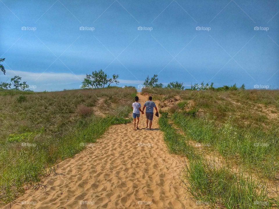 Walking hand-in-hand through the sand