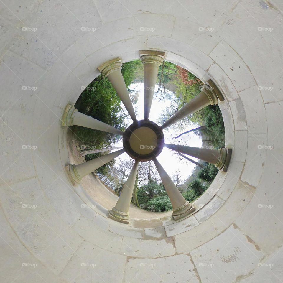 inverted tiny planet photo of temple at fountains Abby