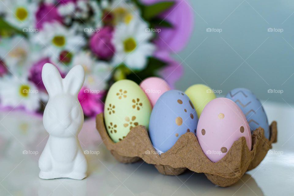 Easter compositions Color eggs and white banny rabbit 