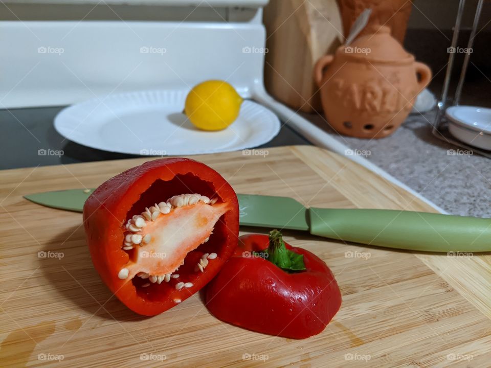 Red Bell Pepper grown in a home garden with lemon and a Garlic cannister