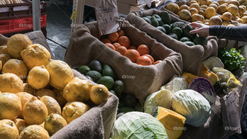 Person taking vegetable from store