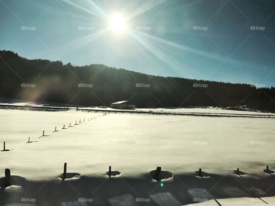 Sun shining on snow mountain in Austria 