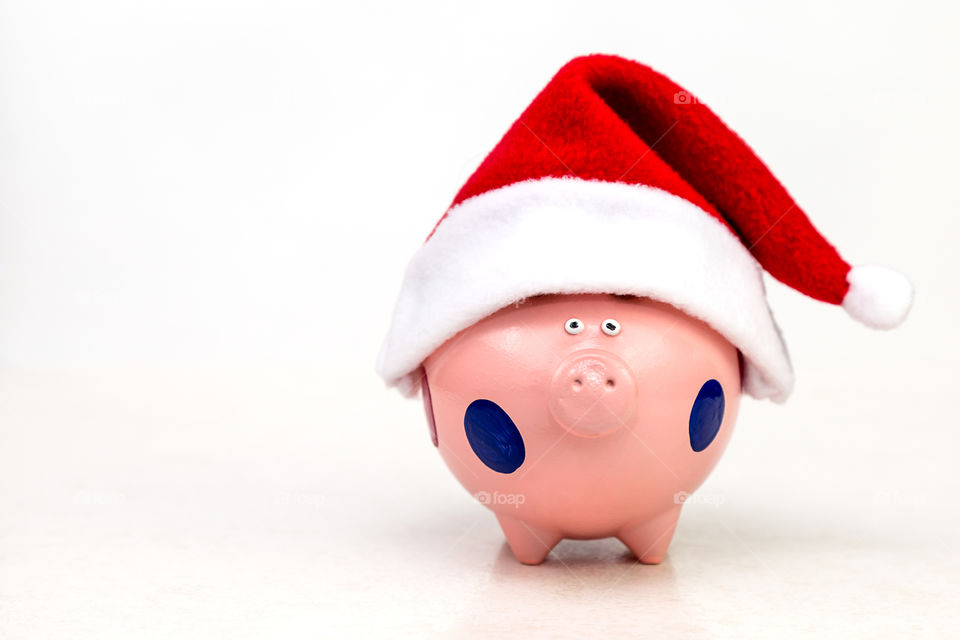 piggy bank in red cap on Christmas Eve
