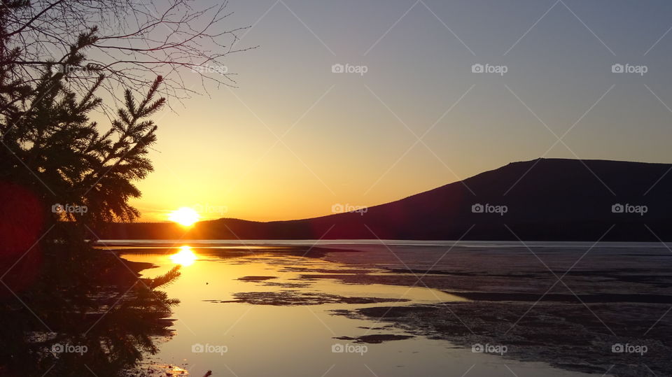 sunset on a reservoir and mountains in the Urals in Russia