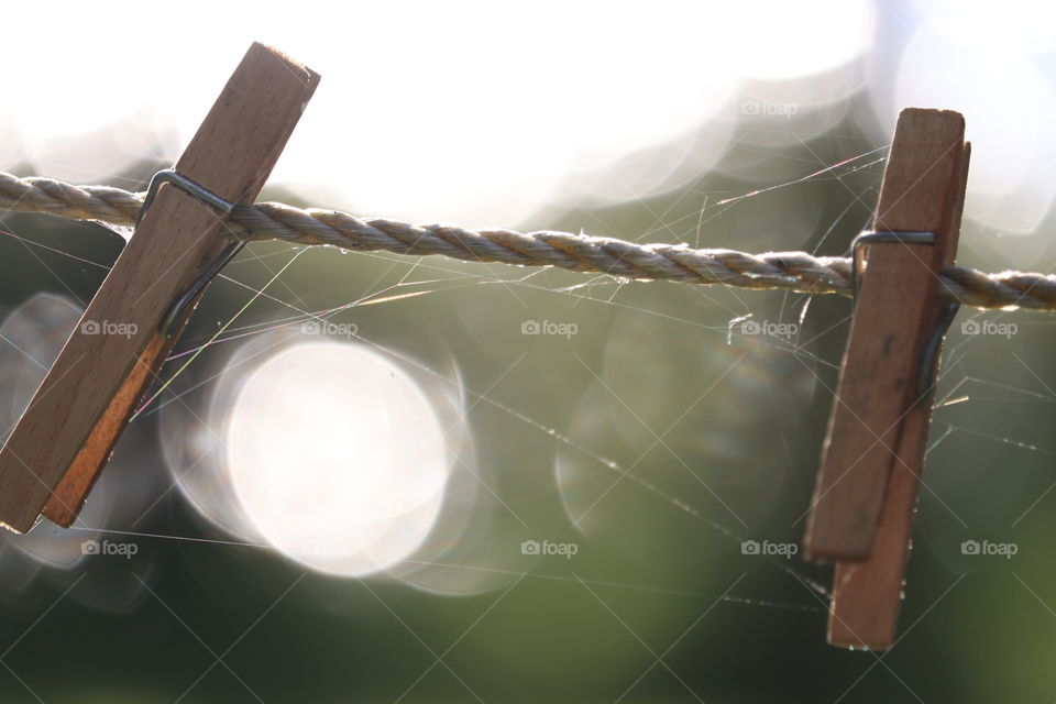 Artistic image, two wood clothesline clothespegs spaced a distance apart: imagery: infertility, love, dating, marriage, childless, delicate, fragility, Dream, balance, harmony, space, time, life, delicate balance, dreams, destiny ....,
