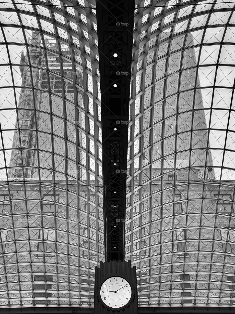 Looking through a glass skylight towards two tall buildings
