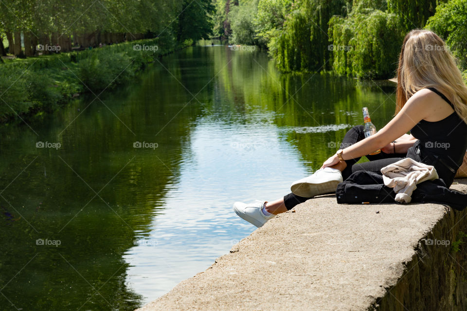 two girls sitting on the riverbank