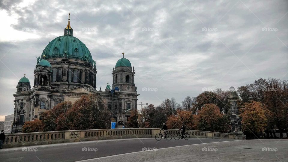 Berlin Cathedral in fall weather and distant bikers