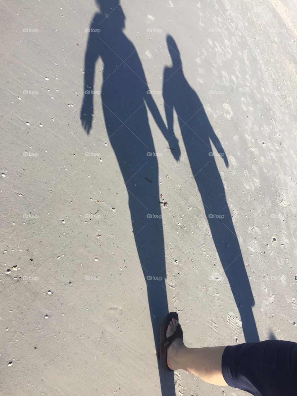 Shadows walking on the beach