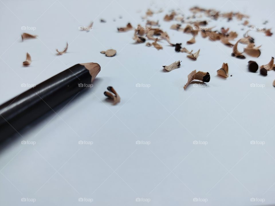 Wood chips caused by sharpening a wooden pencil.