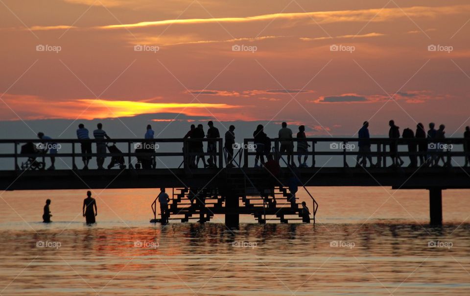 Silhouette of people on bridge