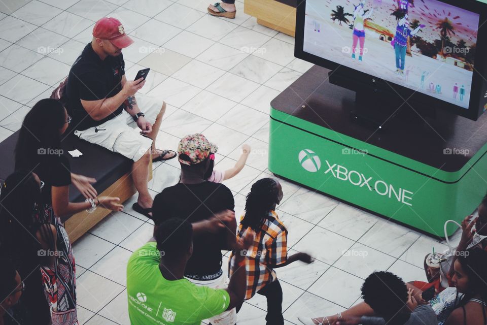 Kids using technology Xbox one at shopping mall Microsoft center 