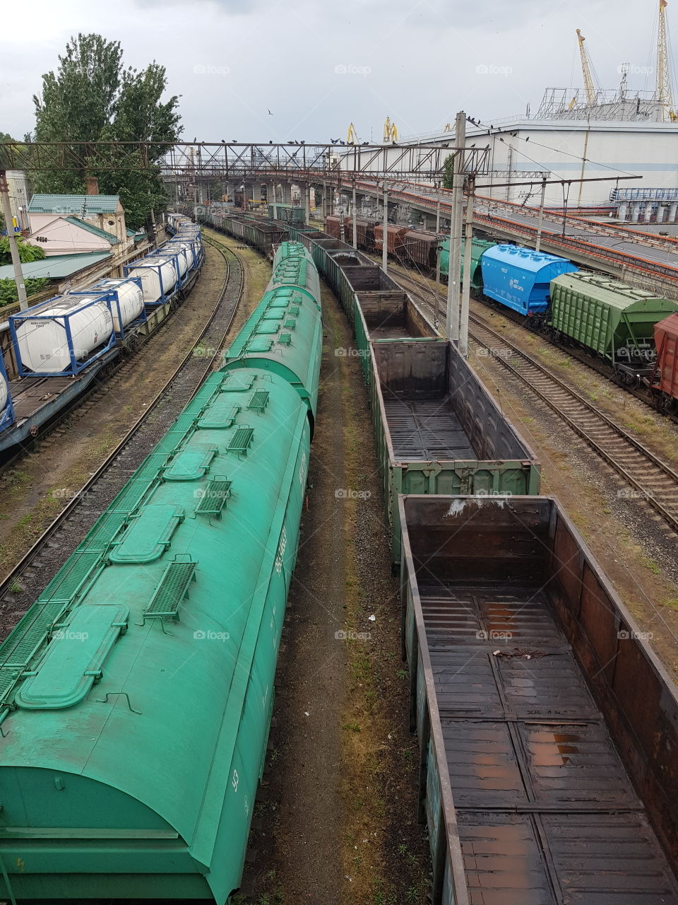 View on rail tracks with various cargo wagons; curve in the distance