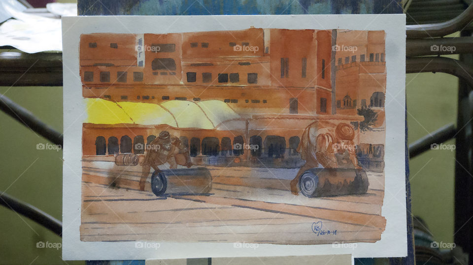 Rolling up the woven mat to clean the floors at the Golden Temple.