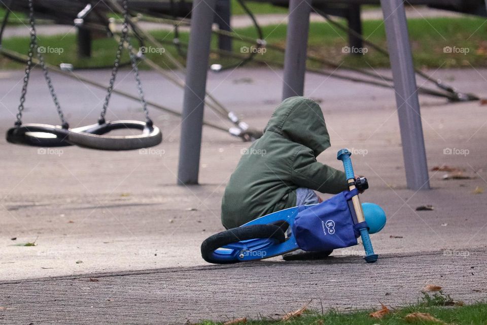 A child and a bicycle on a children's playground