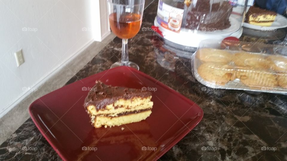 butter cake with chocolate frosting and a glass of wine