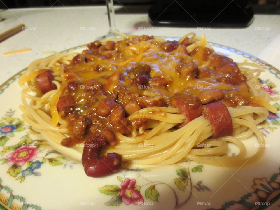 Spaghetti with chili & cheese. Spaghetti & hot dogs topped  with chili