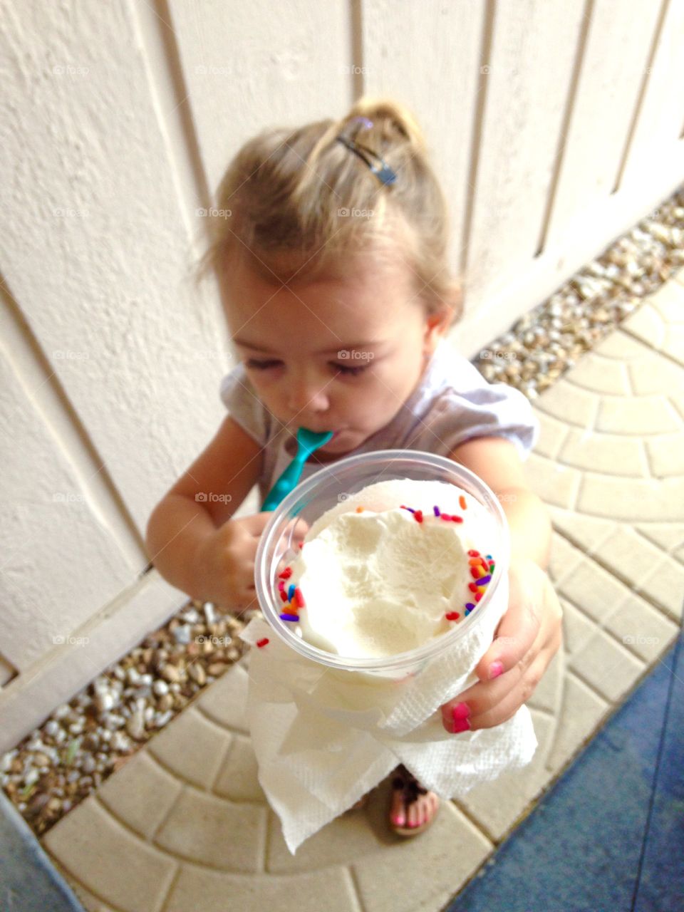 Elevated view of a girl holding ice cream glass