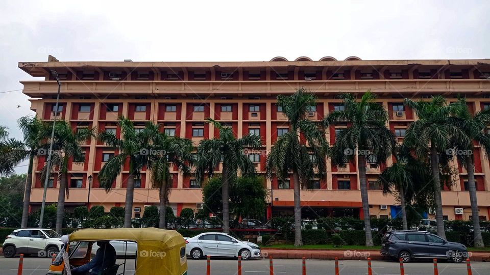 The photo shows two small motorcycles parked in front of a building. It looks like they're all set for a fun ride.