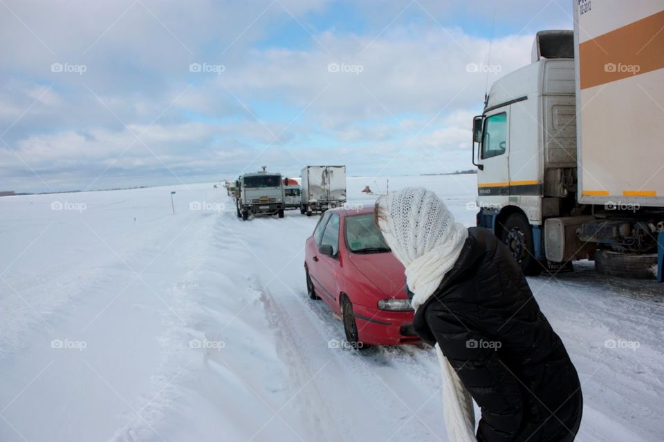 Cars, paralyzed by snow storm in the middle of highway and field. We with our friends had our trip by cars from Kyiv to Minsk for New Year and Christmas celebration. While right before departing, an unusual amount of snow covered Ukraine. 