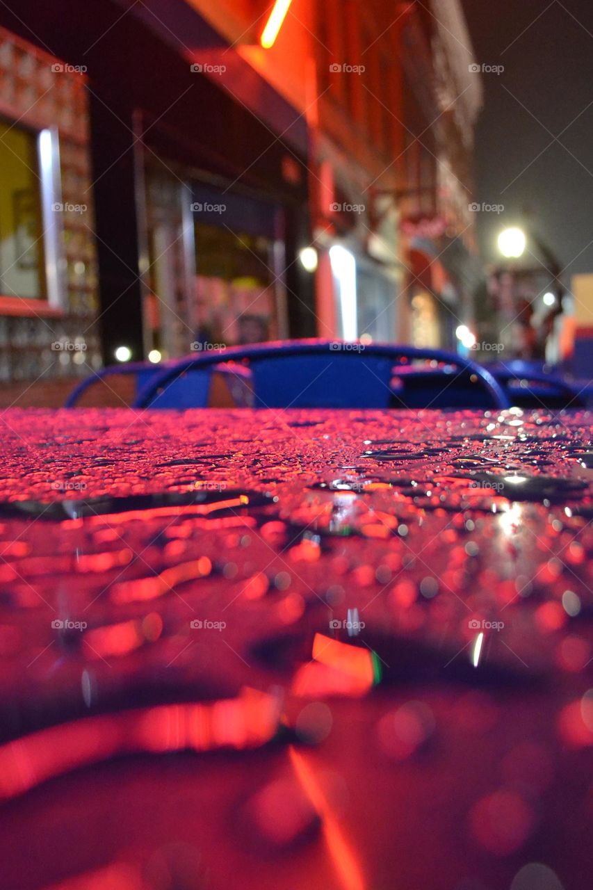 rain pooled on a table top in an outdoor seating area during a 2am walk in Leadville Colorado