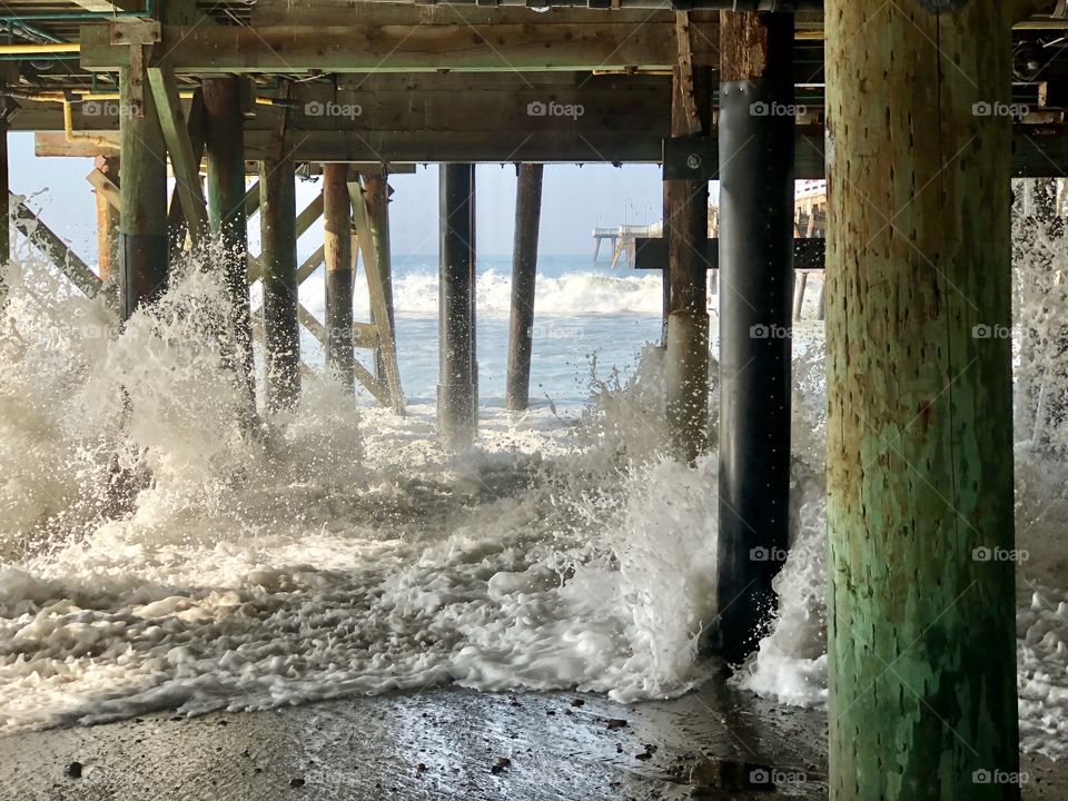 Spectacular Waves Crashing Under a Pier
