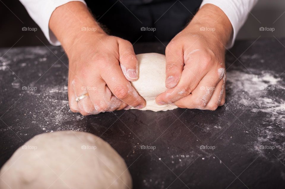 Folding and kneading dough for proofing. Baking bread at home.