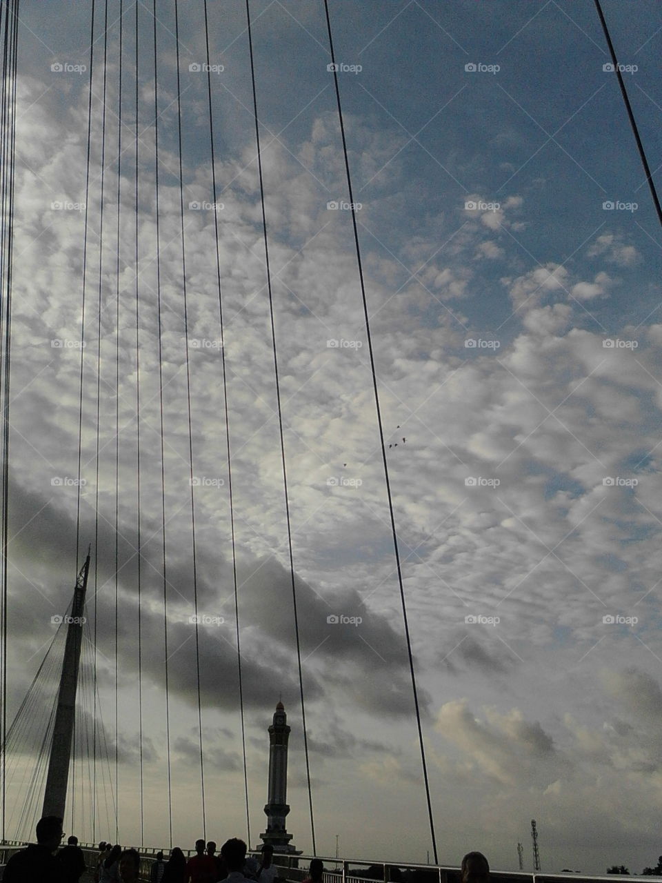 rope to suspension bridge with sky